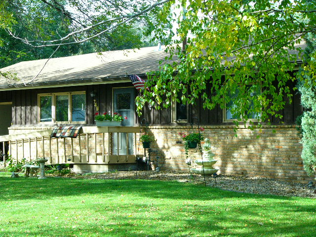 Front view of single-story home on 81st Ave in Spring Lake Park with porch and brick exterior.