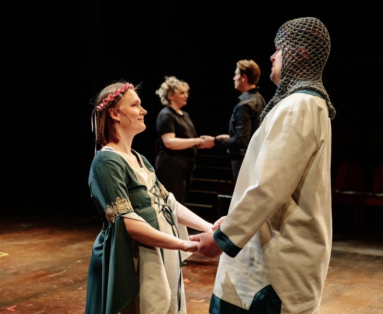Rachel Moquist performs as Lady Larkin in Once Upon a Mattress, holding hands with a castmate on stage.
